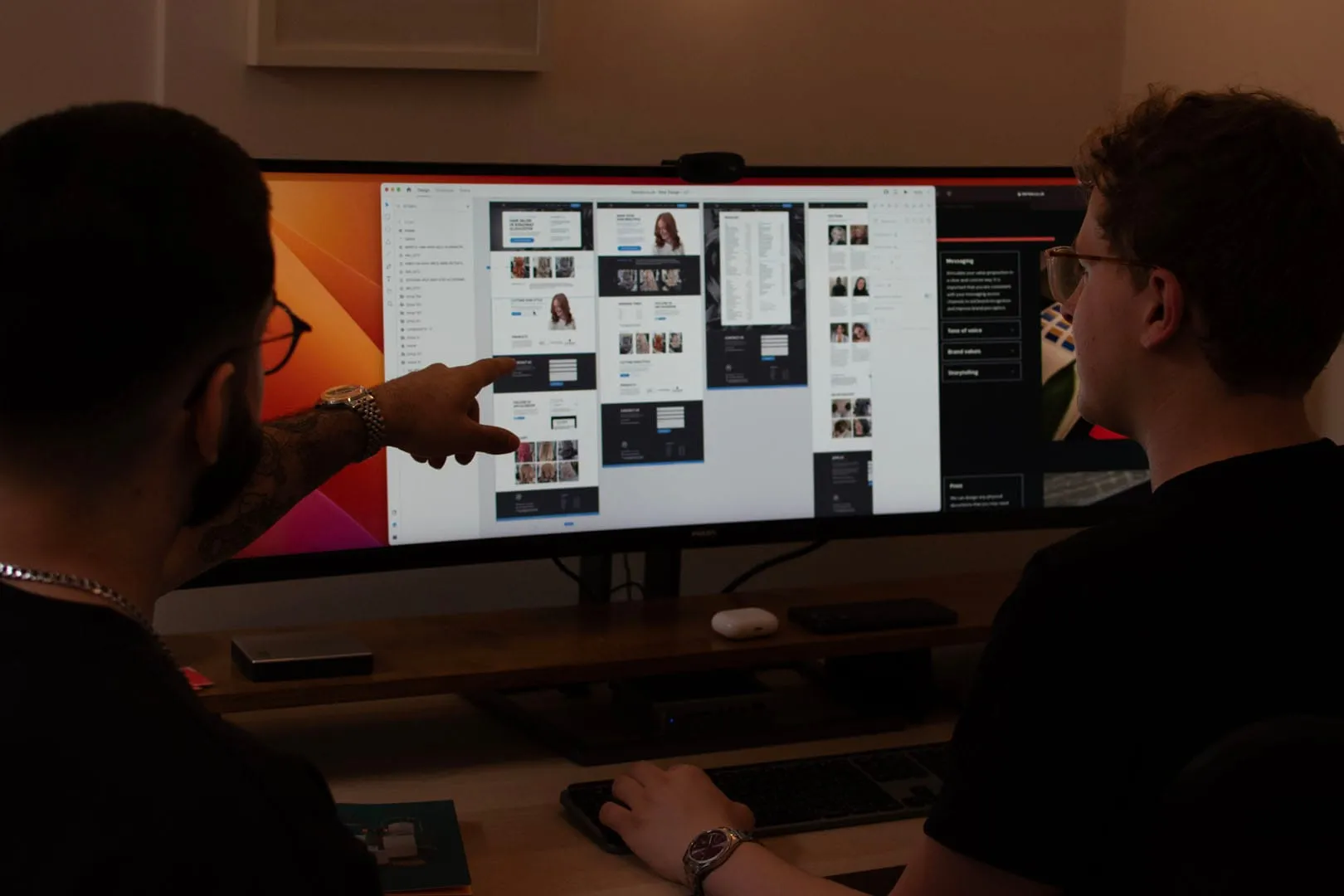 UX design principles for websites. Berlew Design Studio team reviewing a site layout